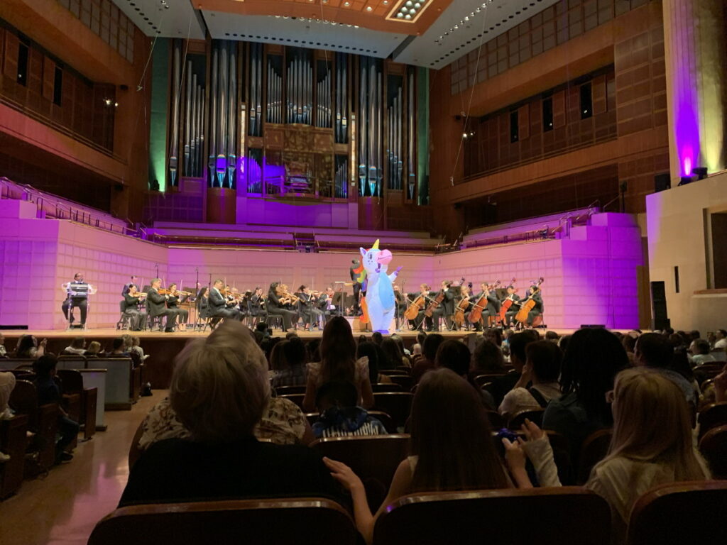 The Unicorn's Birthday® performance with the Dallas Symphony Orchestra. The Birthday Unicorn and the audience conduct the symphony in the rousing final movement